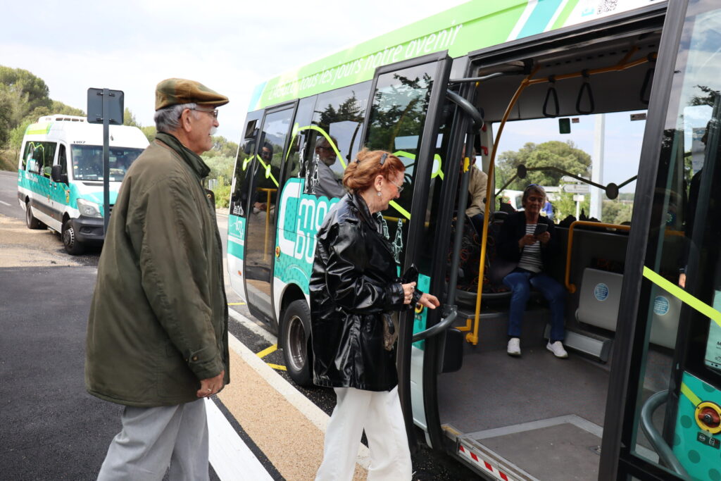 Couple de passagers seniors sur le point de monter dans un bus CmonBus à un arrêt - Agrandir l'image, fenêtre modale