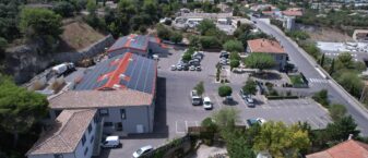 Vue drone du siège LMV avec ses trois bâtiments dont deux sont équipés de panneaux solaires et son parking